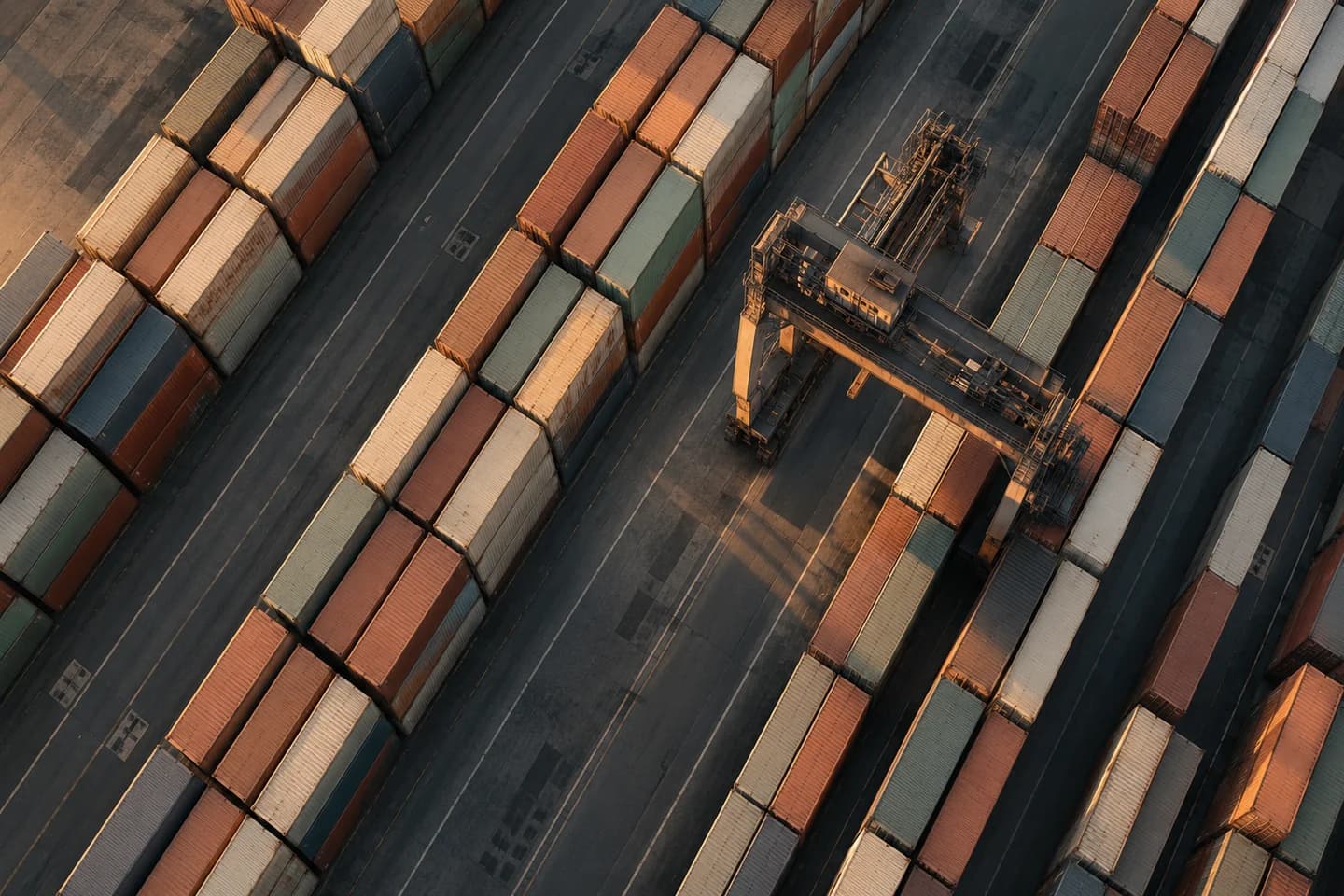 Aerial view of shipping containers arranged across a logistics terminal